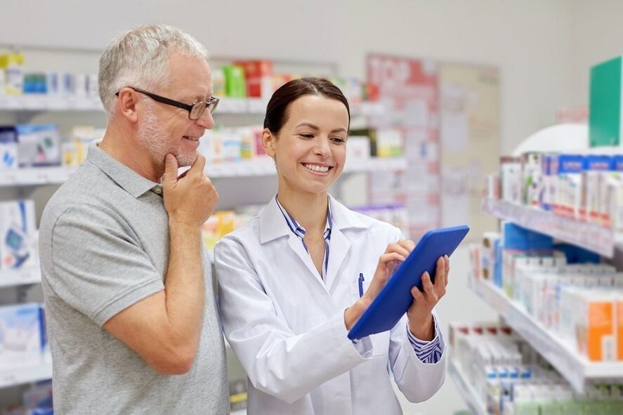 A doctor prescribes a medicine for parasites to a man